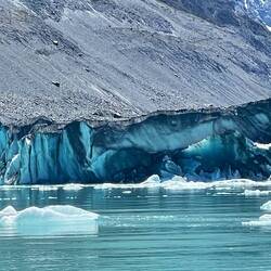 Glacier face blue where ice has recently broken off