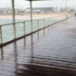 The heavy rain beating down on the jetty at Henley Beach. The man in the video was crab fishing.