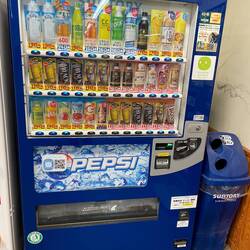 A vending machine for coffee - blue labels are cold and red labels indicate hot coffee