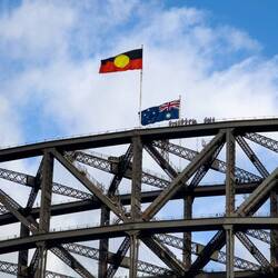 The Aboriginal and Australian flags at the summit of Sydney Harbour Bridge — Sydney, NSW.