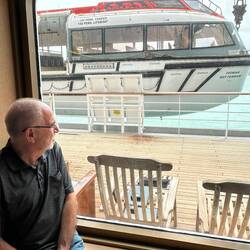John has found a great vantage point to watch the tender launch.