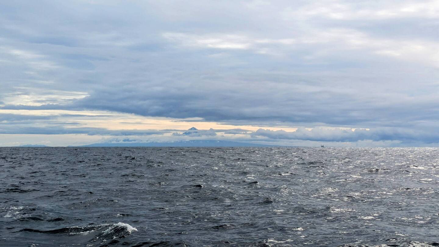 Mount Taranaki wearing her veil of clouds
