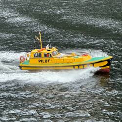 The pilot boat accompanies us out to sea.