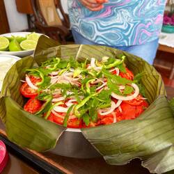Local chicken dish using a paste from the market and banana leaves