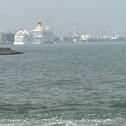Our little Navigator behind larger ship awaiting our return.