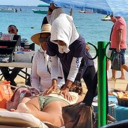 Massage therapists stating on the other side of the rope ... but ... getting customers anyway!