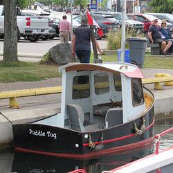 This is Puddle Tug, a tiny tugboat the size of a dingy. So cute.