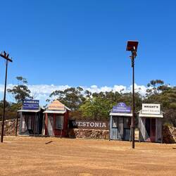 Welcome to Westonia sign with models of original shops