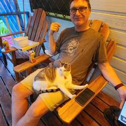 The cat loves Anthony and just jumped up and got comfy