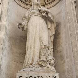 Saint Agata holding the tongs they used to torture her.