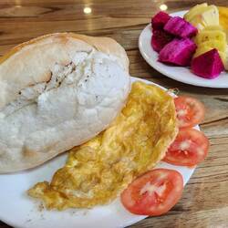 Breakfast: bun, egg, tomatoes and fruit