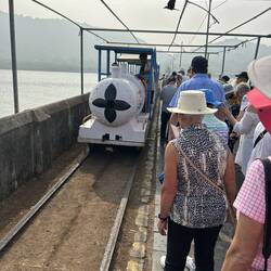 Heather, with hat, while we waited for the trolley to take us off the pier.