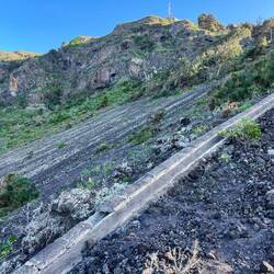 Der Abstieg beginnt am Sendemast / Im Vordergrund ehemalige Wasserleitungen für die Bananenplantagen