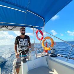 Me at the helm of our boat