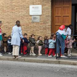Across the street from our place, there is a school. Cute to see the kids hanging on to the hoods.