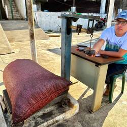 The cooperative weighs and pays farmer for coffee