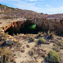 Interesting rock hole carved by the waves