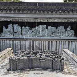 A 3D model and cross section illustration of Kowloon Walled City