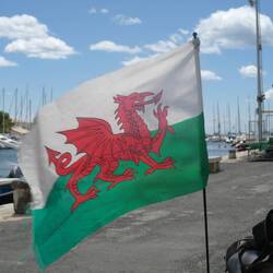 The Welsh dragon flies over the harbour at Meze.