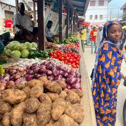 A young woman on the market - apparently with no interest for vegetables
