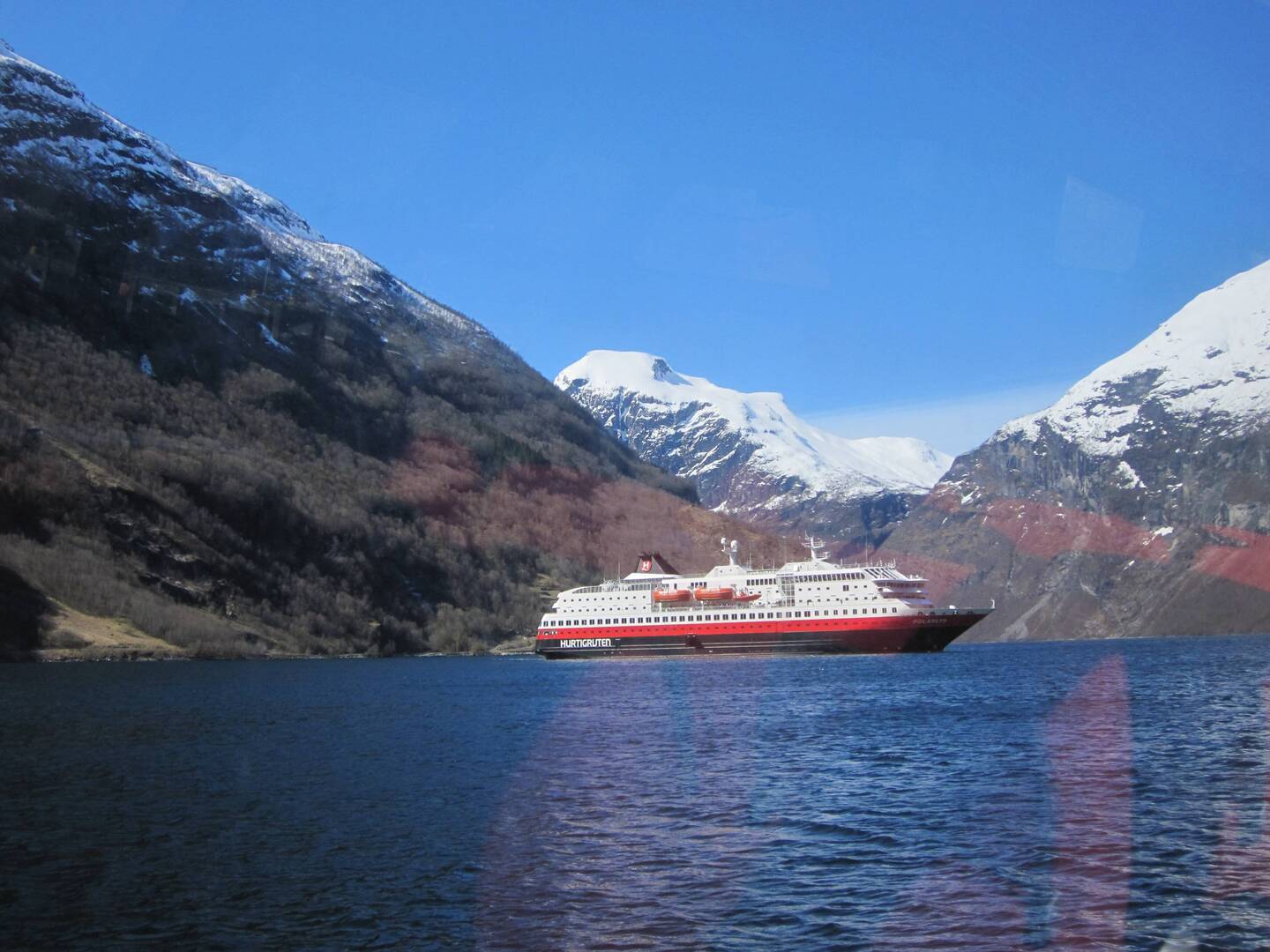 MS Polarlys viewed from the tender; she is seven decks high, but still dwarfed the surrounding peaks