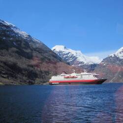 MS Polarlys viewed from the tender; she is seven decks high, but still dwarfed the surrounding peaks