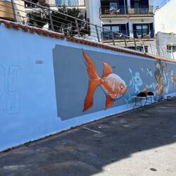 Tolles Graffiti an einer hauswand mit BLick auf den Hafen von L'Ametlla de Mar