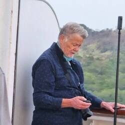 Some old guy that stands out in the sun and wind so he can see ALL of the canal.
