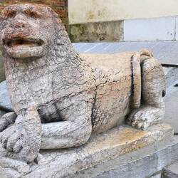 A weather beaten lion guarding the entrance to the cathedral