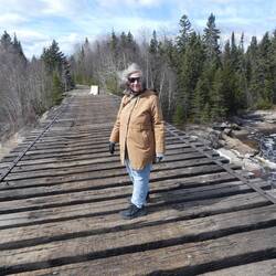A woman on a no longer used railway bridge - the line has gone and is now a walking trail.