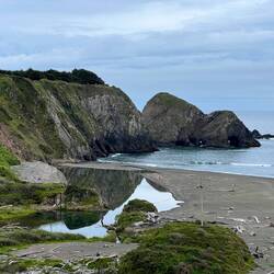 A river pushing through the beach