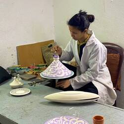 Artist hand painting the pieces