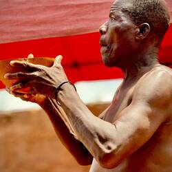 A Village Elder performs blessing to welcome us and keep us safe