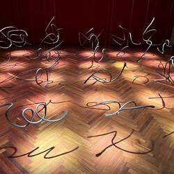 Wire sculptures that make letters with their shadows
