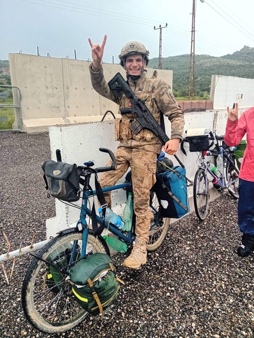 A soldier with a sense of humour testing out Alain's bike. Turkish thumbs up!