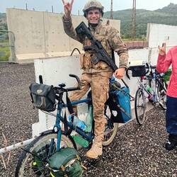 A soldier with a sense of humour testing out Alain's bike. Turkish thumbs up!