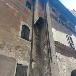 This is an original toilet chute attached to a building that fell directly on to the pavement below