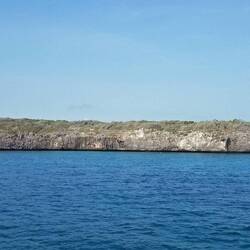 Rocky Dundas South, which has two caves at the waterline.