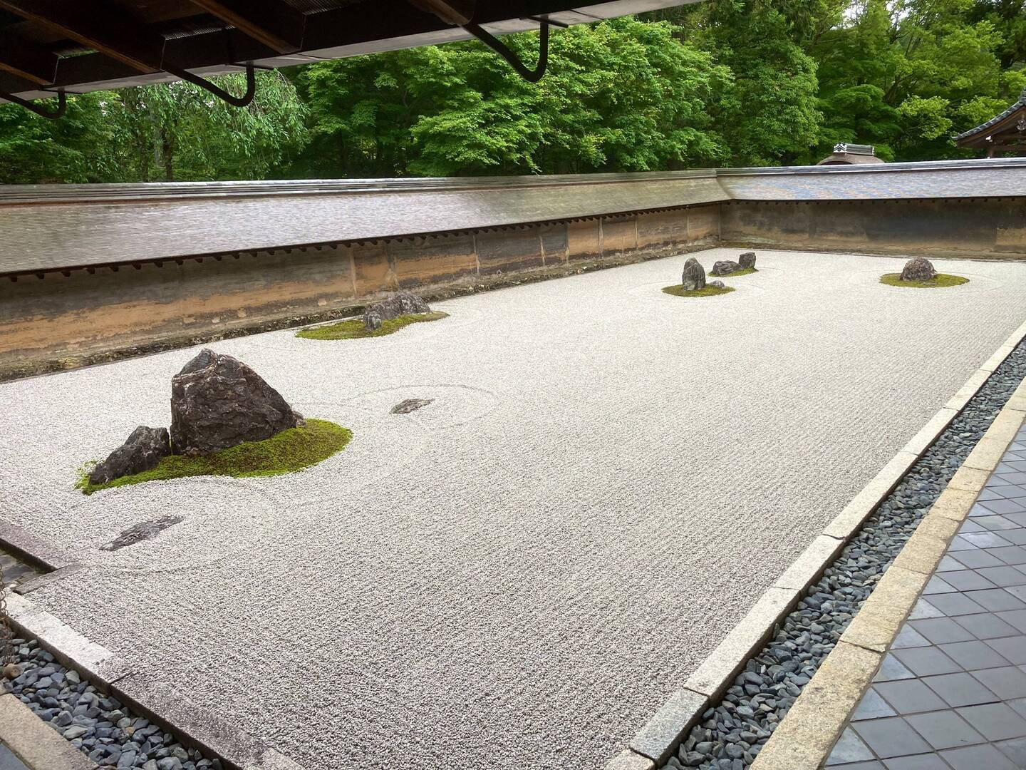 The garden is raked every day by the monks.