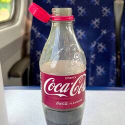 This coke bottle has a lid that stays connected to the bottle