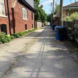 Smart city. Every block has an alleyway do that the garbage does not have to be on the street.