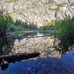 Reflection of sheer granite cliffs in the pond/lake