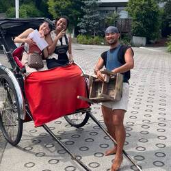 Barefoot man pulling a rickshaw