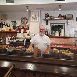 Friendly bar owner displaying his wares
