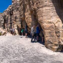Taking turns going into rock art gallery inside these small caves — Bigge Island, Kimberley.