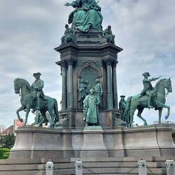 Empress Maria Theresa Monument towering over 4 sets of statues representing a facet of her rule