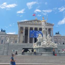 Pallas Athena the God of Wisdom stands proudly outside the portico, alongside ancient historians