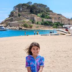 Look at that smile! She loves the sand and sea!