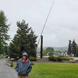 Phil in the rain in front of the World's Largest fly rod at Houston, BC.