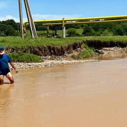 The yellow pipe that is not a bridge. Alain's sun tan line is not due to the murky water.